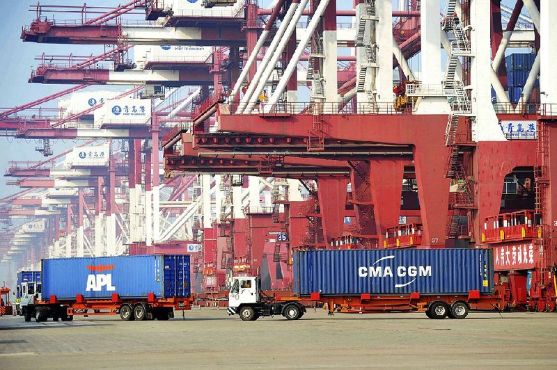 Trucks move shipping containers last week at a port in China’s Shandong province. U.S. commerce chief Wilbur Ross complained to China’s negotiator Wednesday that imports from China have grown much faster than U.S. exports to China. 
