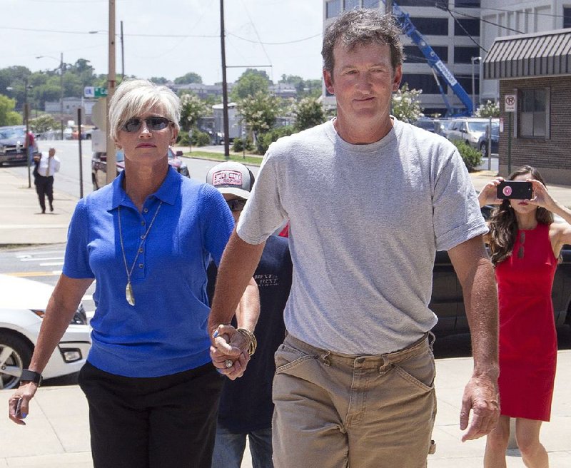 Accompanied by his wife, Dawn, and his two sons, former Circuit Judge Michael Maggio arrives Wednesday at the federal courthouse in Little Rock, where he surrendered to U.S. marshals to begin serving a 10-year prison sentence for bribery. Maggio called it “a tough, tough day for me, my family, my friends, my supporters.”  
