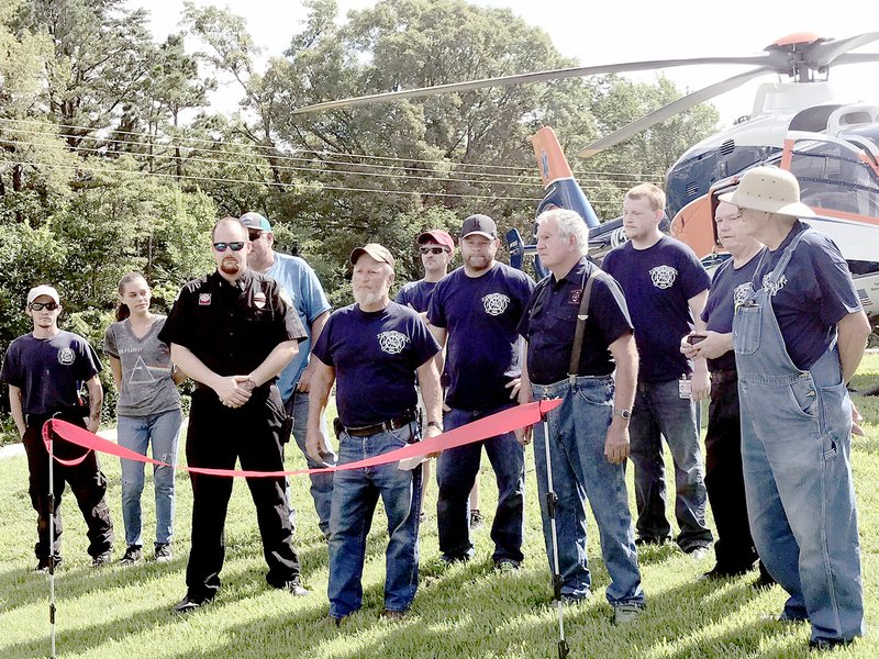 Sally Carroll/McDonald County Press White Rock Fire Department crew members dedicate the new helicopter landing pad Saturday morning.