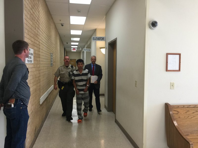 NWA DEMOCRAT-GAZETTE/TRACY M. NEAL A sheriff&#8217;s deputy escorts Mei Ka Sin Thursday, July, 20, 2017 to a room in the Benton County Courthouse where he can speak with Jay Saxton, Benton County&#8217;s chief public defender. Sin was arrested in connection with capital murder and is being held without bond in the Benton County Jail.