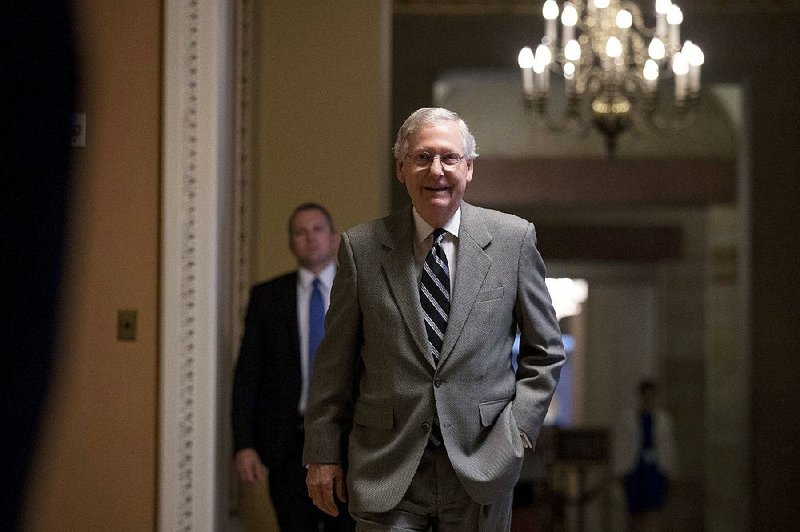 Senate Majority Leader Mitch McConnell heads into the Senate chamber on Thursday. “Dealing with [the health care bill] is what’s right for the country,” he said.