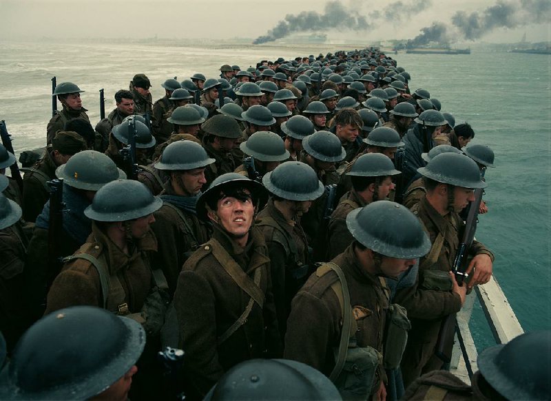 Tommy (Fionn Whitehead, foreground, looking up) is a 19-year-old English private trying to escape the German forces and make it home in Christopher Nolan’s Dunkirk.