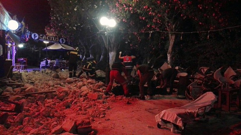 Firefighters and rescuers try to clean a road from the stones after an earthquake on the Greek island of Kos early Friday, July 21, 2017. A powerful earthquake struck Greek islands and Turkey's Aegean coast early Friday morning, damaging buildings and a port and killing at least two people, authorities said. (Kostoday.gr via AP)