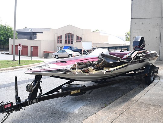 The Sentinel-Record/Mara Kuhn DAMAGED VESSEL: Dillon Abernathy's damaged bass boat was parked outside of the Garland County Sheriff's Department on Thursday so that it could be examined by investigators.