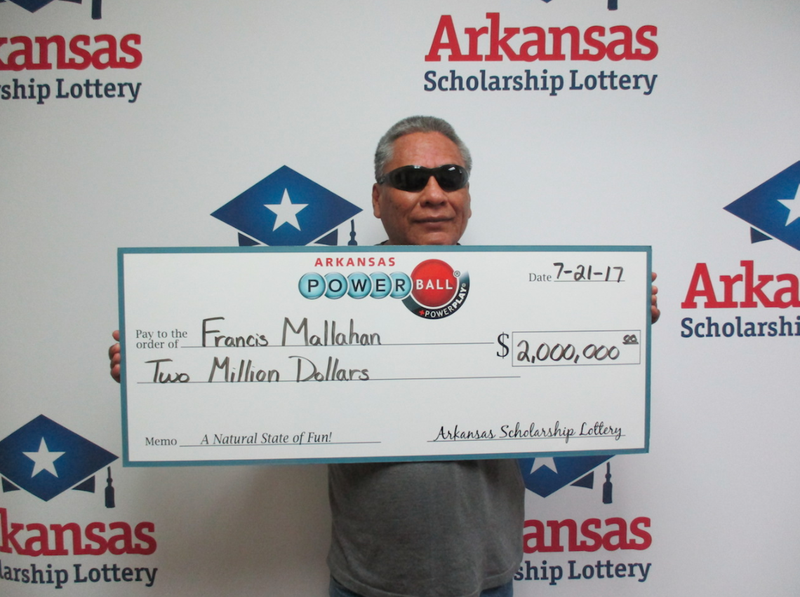 Francis Mallahan is shown with an oversized check in this photo provided by the Arkansas Scholarship Lottery.