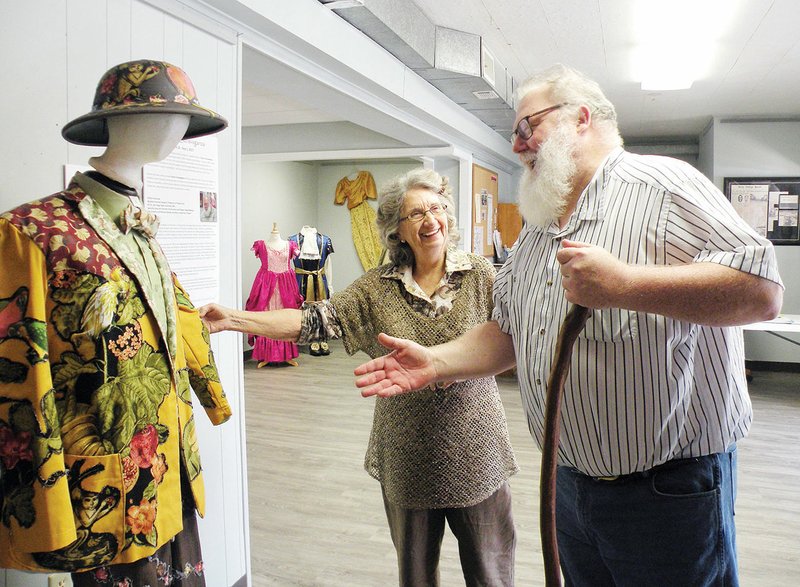 William Henshaw, right, resident costume designer and professor of theater arts at Henderson State University, and Farrell Ford, executive director of the Clark County Arts and Humanities Council, discuss one of the costumes in the exhibit Fashion Extravaganza at the Arkadelphia Arts Center. Henshaw designed and made the costume for Hotel Cassiopeia, by Charles Mee, when the HSU theater department presented the play several years ago.