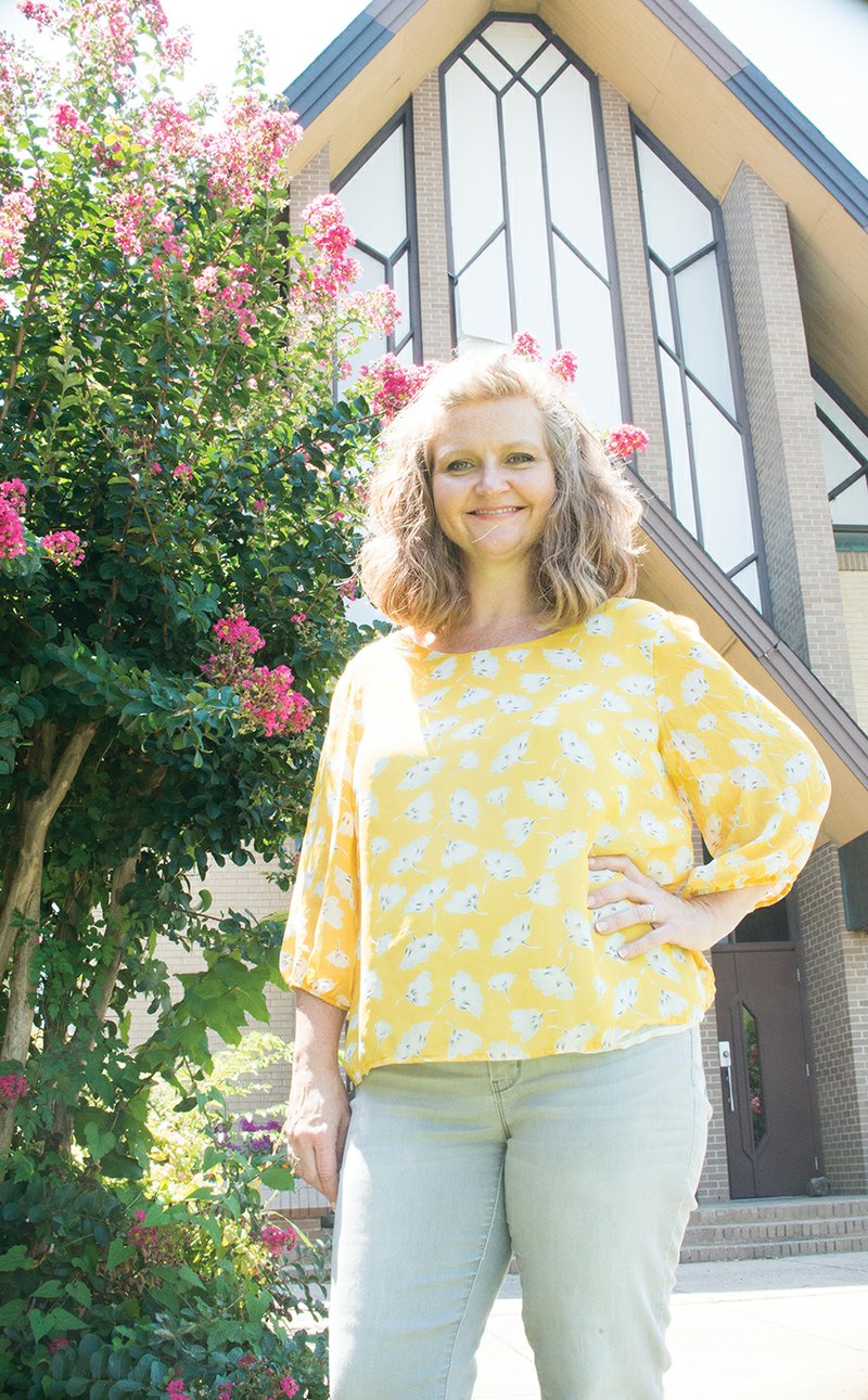 Spring Hunter stands outside the Conway Ministry Center, which is housed in the former Second Baptist Church on Harkrider Street. The nonprofit organization is a central location for people to find help with housing, food, clothing and other needs. Hunter, a mother of five, took over July 3 as the center’s executive director.