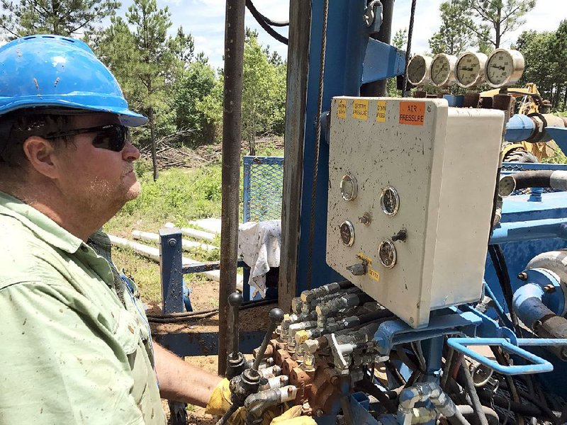 Tim Tyler, director of Water for Christ, checks the pressure gauges on the nonprofi t’s drilling rig at the future site of Hebron Hills, an after-care facility for survivors of the sex-trafficking industry.