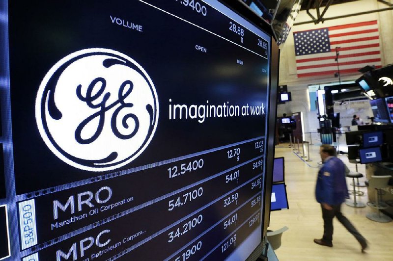 The General Electric logo appears on a screen above a trading post on the floor of the New York Stock Exchange in mid-June. The company on Friday reported revenue of $29.56 billion in its quarterly report.