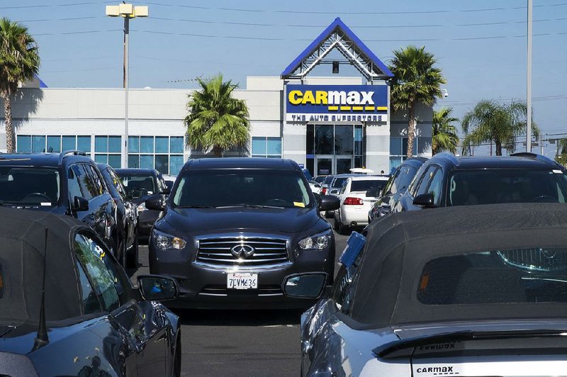 Used cars fill the lot at a CarMax dealership in Inglewood, Calif., in June. A glut of used cars resulting from expired lease deals will soon fl ood the auto market, driving down the number of new-car sales, according to a recent report by consulting firm AlixPartners.