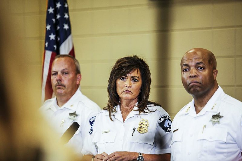 Minneapolis police chief Janee Harteau, center, stands with police inspector Michael Kjos, left, and assistant chief Medaria Arradondo during a news conference Thursday, July 20, 2017, Minneapolis. It was the first time she appeared publicly since the police shooting death of Justine Damond on Saturday. 