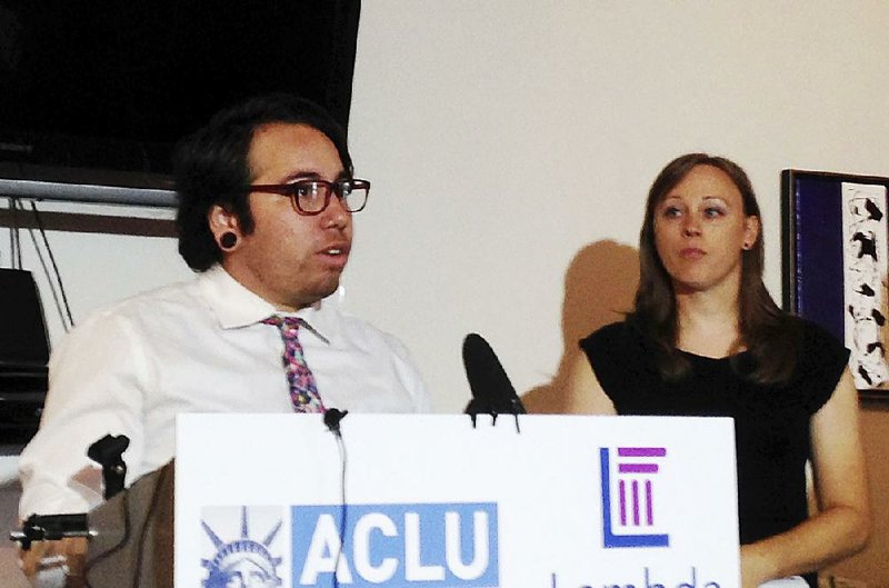 Joaquin Carcano speaks Friday during a news conference in Raleigh, N.C., announcing a new lawsuit over LGBT rights. Carcano and Madeline Goss (right) are plaintiffs in the lawsuit.