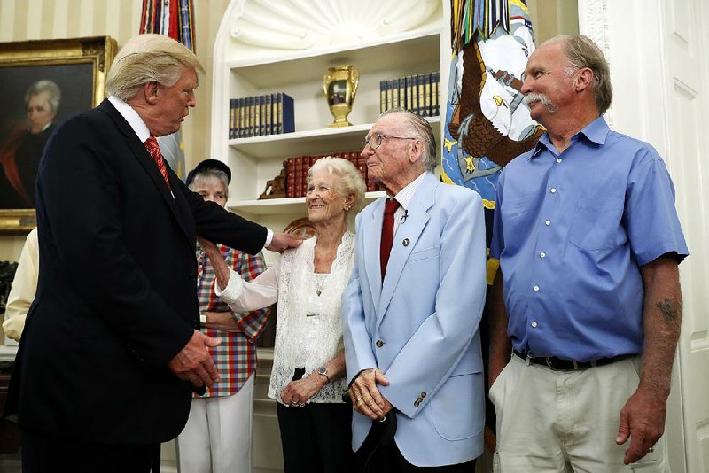 President Donald Trump greets Velma Stratton and USS Arizona survivor Donald Stratton during a meeting Friday in the Oval Office with survivors of the Dec. 7, 1941, attack at Pearl Harbor. Stratton is one of two men who attribute their survival to an Arkansas man, Joe George, who threw them a lifeline from a nearby vessel.