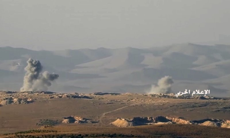 This frame grab from video released on Friday, July 21, 2017 and provided by the government-controlled Syrian Central Military Media, shows smoke rising while Hezbollah cannons pounding militants' positions on the Lebanon-Syria border. 