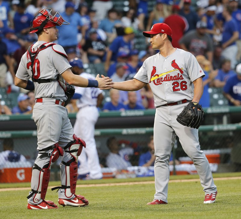 St. Louis Cardinals catcher Carson Kelly, left, celebrates with relief pitcher Seung-Hwan Oh after the Cardinals' 11-4 win over the Chicago Cubs in a baseball game Friday, July 21, 2017, in Chicago. 