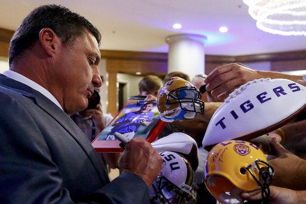 LSU NCAA college football coach Ed Orgeron signs autographs during the Southeastern Conference's annual media gathering, Monday, July 10, 2017, in Hoover, Ala. (AP Photo/Butch Dill)