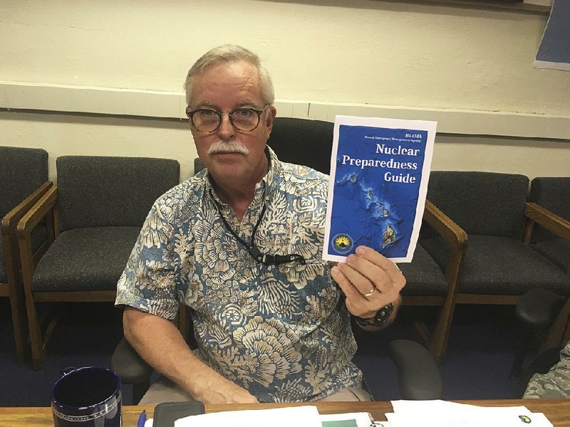 Toby Clairmont, executive director of the Hawaii Emergency Management Agency, shows off new informational materials Friday in Honolulu. Hawaii announced a public education campaign focused on what to do if North Korea attempts a missile strike.
