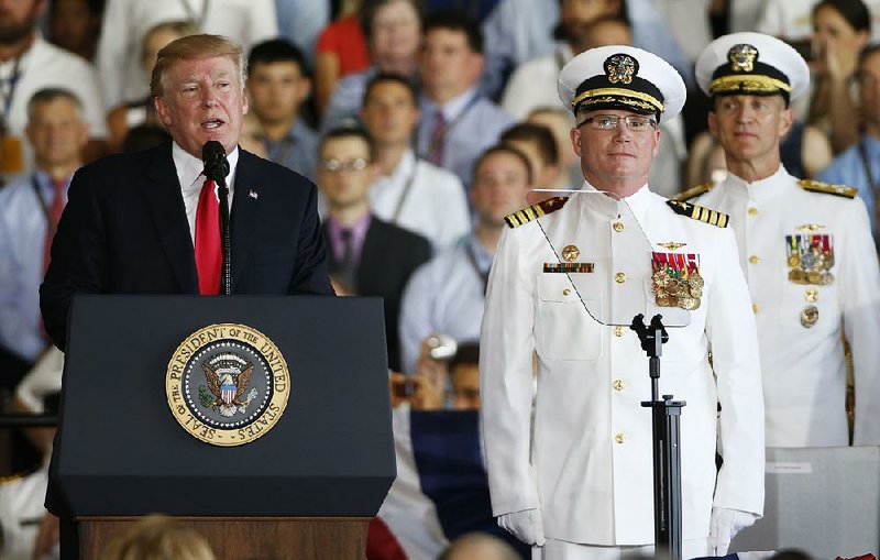 President Donald Trump is joined by Capt. Richard McCormack, the skipper for the USS Gerald R. Ford, as he delivers a speech Saturday at the aircraft carrier’s commissioning.