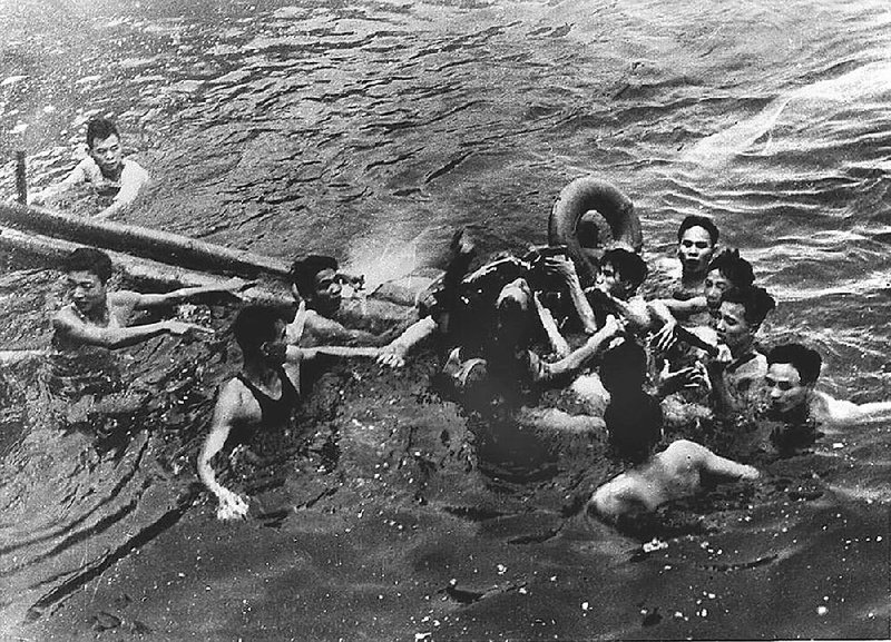 North Vietnamese civilians capture John McCain (center) in Truc Bach Lake near Hanoi after his fighter jet was shot down Oct. 26, 1967. McCain broke both arms and a leg, then was bayoneted and beaten.