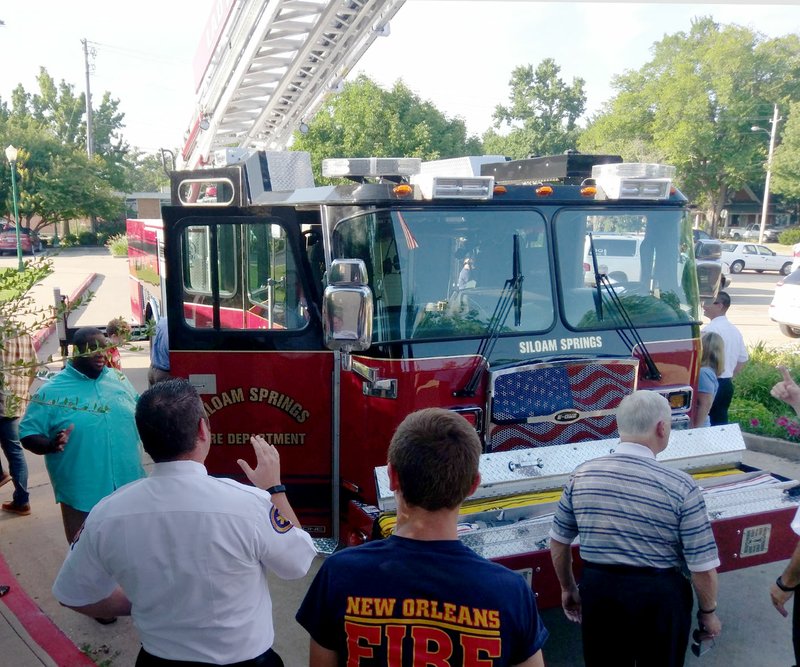 Michael Burchfiel/Siloam Sunday Those at the board meeting got a first look at Siloam Springs&#8217; newest fire apparatus: a 2017 E-One Cyclone ladder truck.