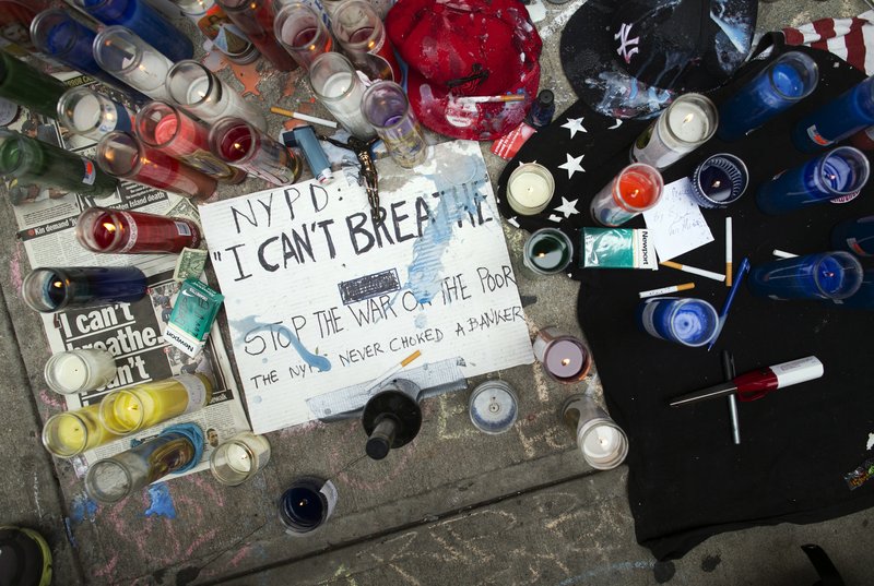 This July 19, 2014 file photo shows a memorial for Eric Garner on the pavement near the site of his death when taken into custody by police, in the Staten Island borough of New York. 