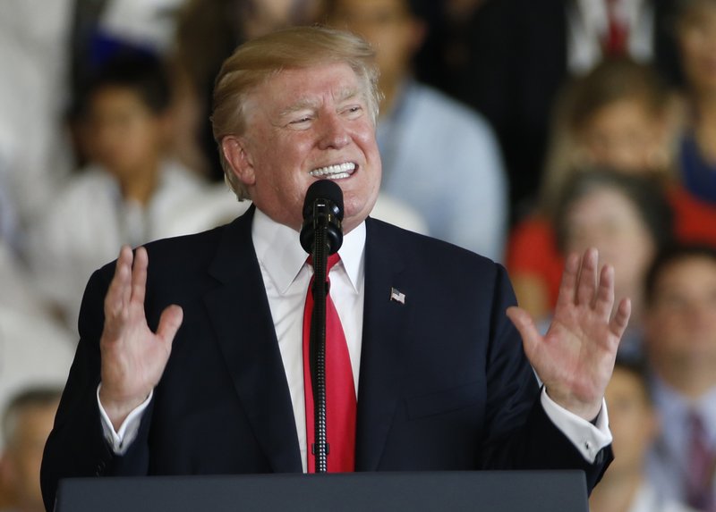 President Donald Trump gestures during a speech aboard the nuclear aircraft carrier USS Gerald R. Ford for it's commissioning at Naval Station Norfolk in Norfolk, Va., Saturday, July 22, 2017. (AP Photo/Steve Helber)