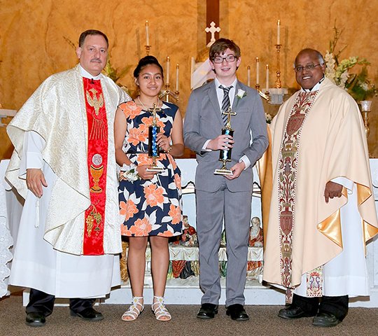 Submitted photo St. John's Catholic School presented the Mercy Christian Witness Award to two students this year because of a tie vote from their classmates. The award is presented each year to students who carry out the Works of Mercy and is a witness to their faith as living examples of the Charism of Catherine McAuley, foundress of the Sisters of Mercy, as voted upon by other students. From left are Pastor George Sanders; Maria Roblero-Vasquez, award recipient; Christian Smith, award recipient; and Pastor Chinnaiah Irudayaraj Yeddanapalli.