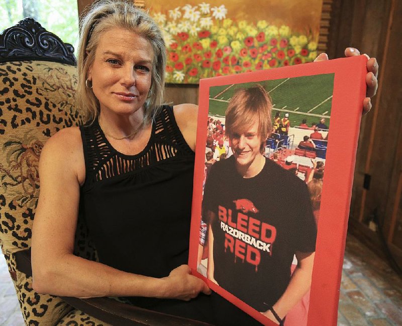 Piper Partridge holds a photo of her son, Keagan Schweikle, 17, who was shot and killed in 2016 by a Benton police officer.