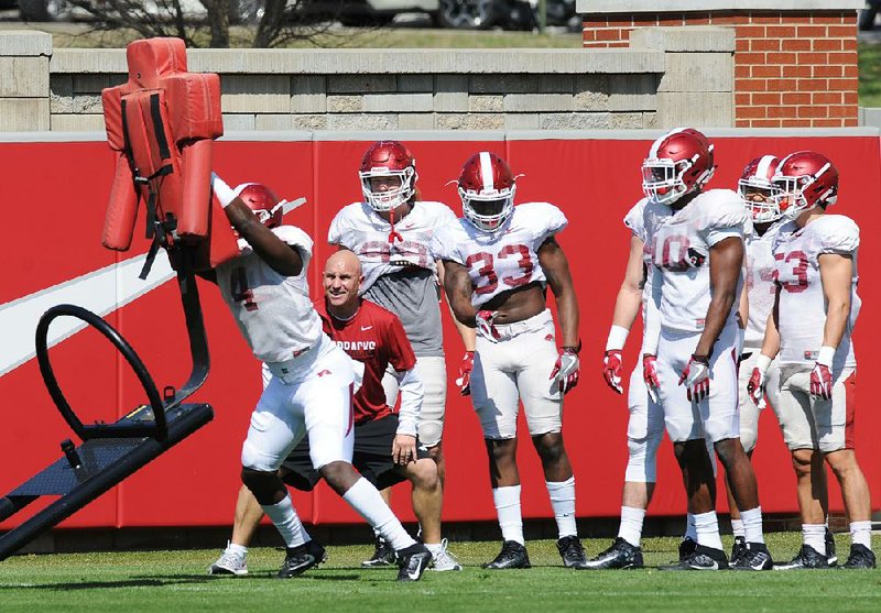 Redshirt freshman linebacker Alexy Jean-Baptiste (left) is still recovering from surgery in April to repair a broken foot and will not participate in Arkansas’ fi rst practice Thursday, Coach Bret Bielema said Monday to reporters in Rogers.