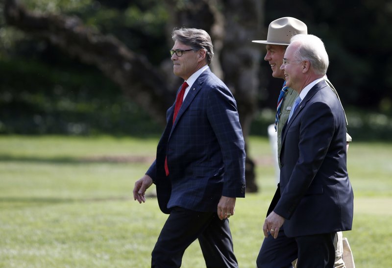 From left, Energy Secretary Rick Perry, Health and Human Services Secretary Tom Price and Interior Secretary Ryan Zinke walk across the South Lawn of the White House in Washington, Monday, July 24, 2017, before boarding Marine One to join President Donald Trump for the short flight to nearby Andrews Air Force Base, Md. Trump is traveling to Beaver, W.Va. to speak at the 2017 National Scout Jamboree. 