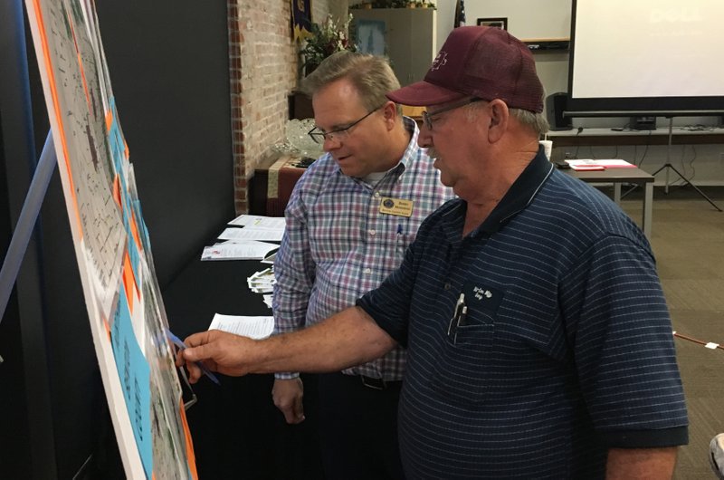 NWA Democrat-Gazette/TOM SISSOM
County Judge Barry Moehring (left) discusses county roads with Gary LaRue of Siloam Springs at Monday's town hall meeting in Gentry.
