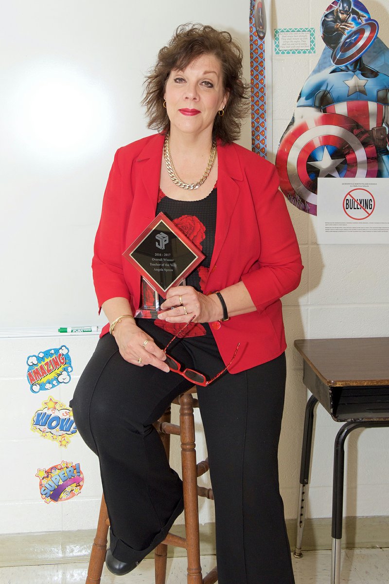 Angela Sprow holds her Teacher of the Year award in her classroom at Bayou Meto Elementary School in Jacksonville. Sprow said her goal is to help students become better thinkers while developing their own unique gifts and talents.