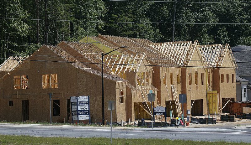 The frames for new town homes are completed in this May 16 photo from Woodstock, Ga. A home price index released Tuesday based on sales in 20 U.S. cities said prices increased 5.6 percent in May. 