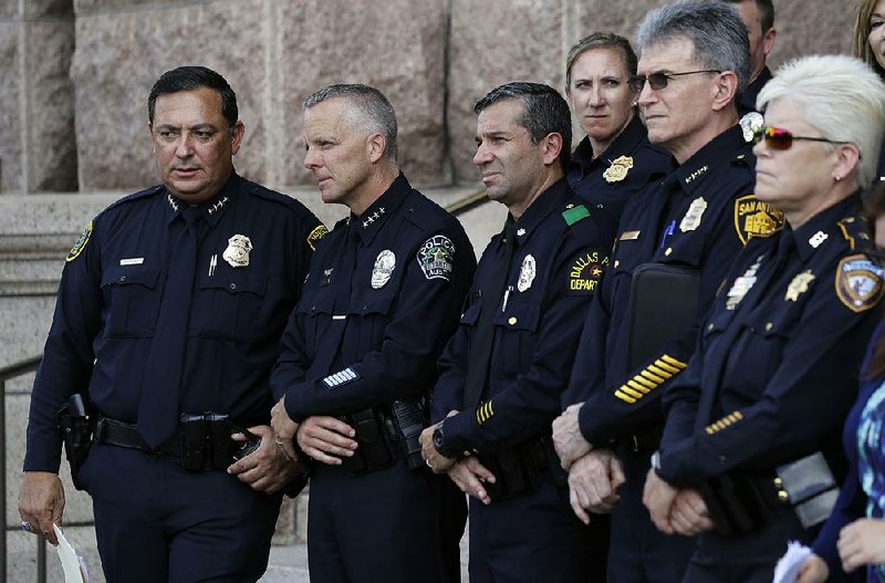 Houston Police Chief Art Acevedo (from left), Austin Police Chief Brian Manley, Dallas police Maj. Rueben Ramirez and San Antonio Police Chief William McManus join other Texas police officials Tuesday at the state Capitol to speak against the proposed “bathroom bill.”  