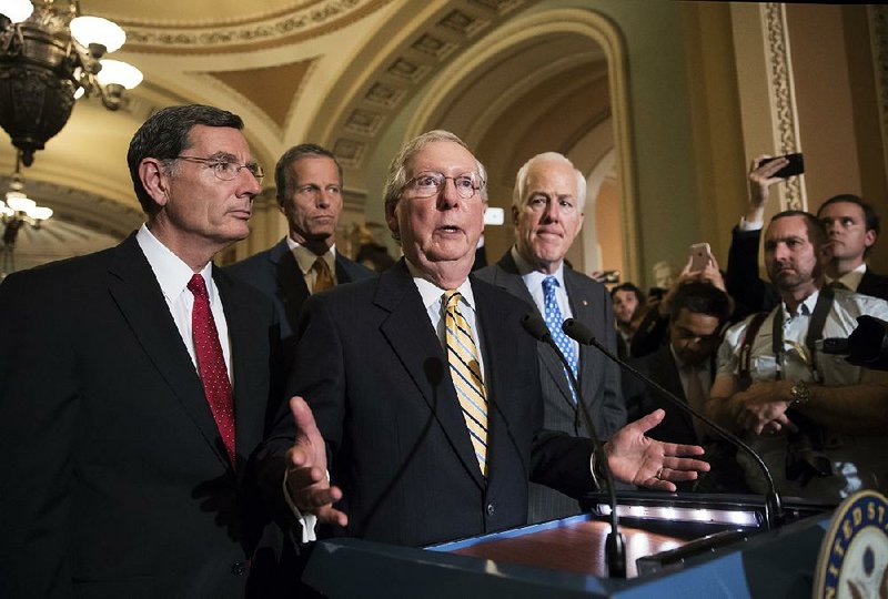 Senate Majority Leader Mitch McConnell on Tuesday discusses the Senate vote to start debate on a health care repeal bill. With him are Republican Sens. John Barrasso of Wyoming, John Thune of South Dakota and Majority Whip John Cornyn of Texas. 