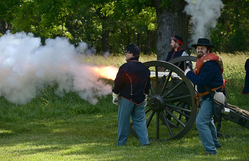 Staff photograph by Ben Goff A team of volunteer interpreters, including Matt Slaughter (from left) of Rogers, Jim Spillars of Fayetteville and Robert Kroening of Fayetteville, fire a blank charge recently at the Pea Ridge National Military Park artillery demonstration. The park performs the interpretive living history presentations roughly every other week from May through September. The next demonstration will be Saturday, July 29. See The TIMES community calendar or check out the PRNMP website https://www.nps.gov/peri/index.htm for dates and times.