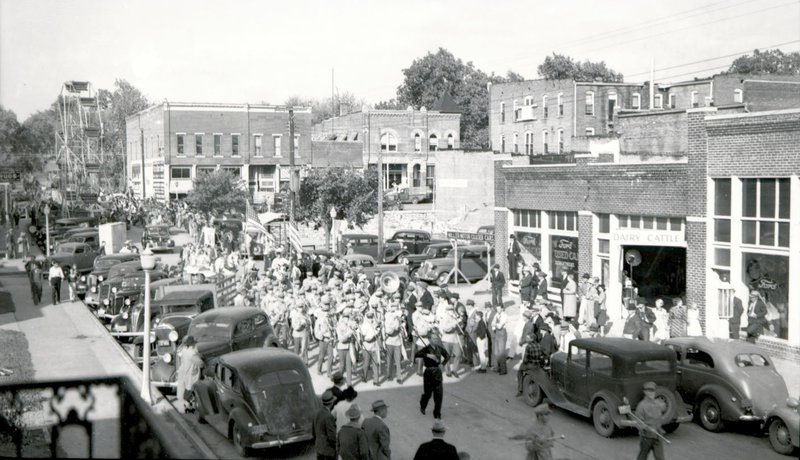 Photo courtesy of the Siloam Springs Museum A picture from the early 1930s shows a parade, complete with Ferris wheel, making its way down North Mt. Olive Street. The picture was taken from the second story of what is now Fire Station 2. The corner of the Herald-Leader office, can be seen on the right side of the picture. A sign on the window reads &quot;Miller Motor Co. Used Cars,&quot; and the building has a gas pump outside.