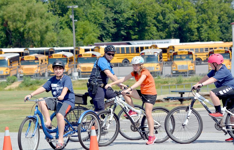 Michael Burchfiel/Herald-Leader Police officers led a camp Monday through Wednesday for children who are interested in a career in law enforcement. Kids heard presentations from different law enforcement agencies and got hands-on experience on topics like police cycling.