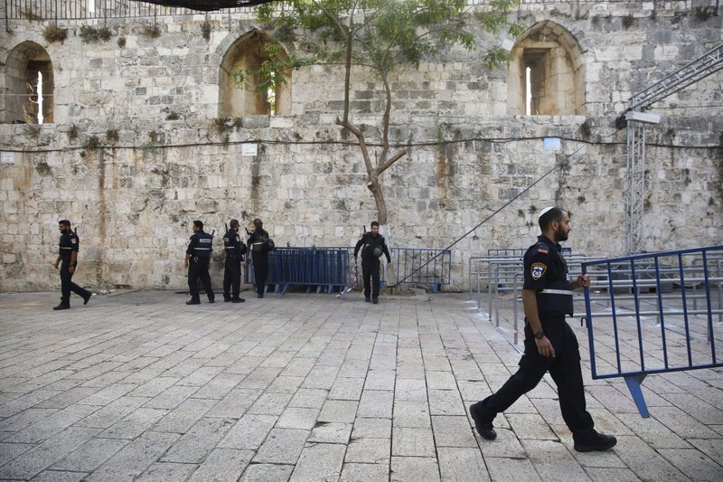 Israeli police officers walk outside the Al-Aqsa Mosque compound in Jerusalem's Old City, Tuesday, July 25, 2017. Israel has begun dismantling metal detectors it installed a week earlier at the gates of a contested Jerusalem shrine, amid widespread Muslim protests. (AP Photo/Oded Balilty)