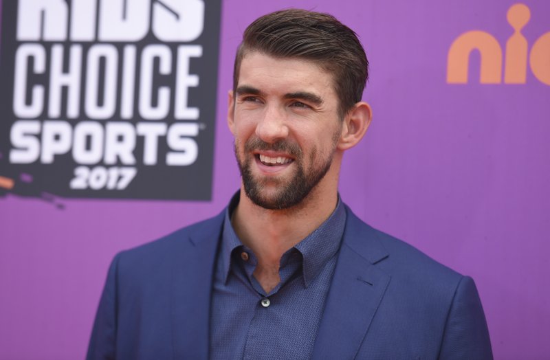 In this July 13, 2017 file photo, retired Olympic swimmer Michael Phelps arrives at the Kids' Choice Sports Awards at UCLA's Pauley Pavilion in Los Angeles. Phelps lost to a shark in the Discovery Channel’s Shark Week special “Phelps vs. Shark: Great Gold vs. Great White," which aired on July 23, 2017. It was billed as a race between Phelps and the predator but much to the disappointment of some Twitter users, Phelps didn’t actually swim in the water next to the shark.