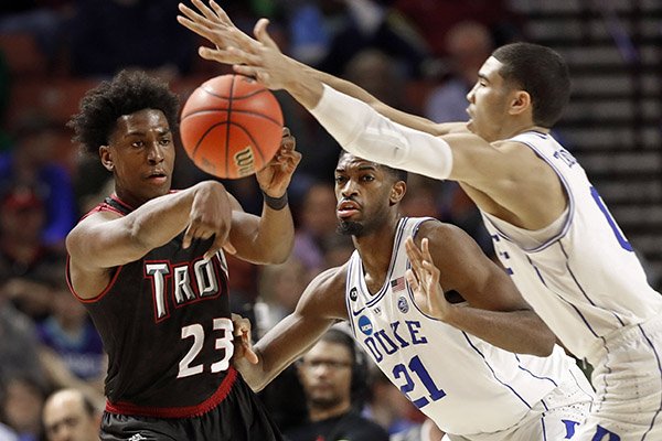 Troy's Jordon Varnado (23) passes the ball past Duke's Jayson Tatum (0) and Amile Jefferson (21) during the second half in a first-round game of the NCAA men's college basketball tournament in Greenville, S.C., Friday, March 17, 2017. (AP Photo/Chuck Burton)
