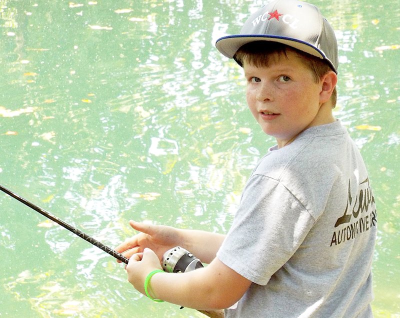 Cale Bray, 10, enjoys an afternoon of fishing at the Flint Creek Nature Park in Gentry on Saturday.