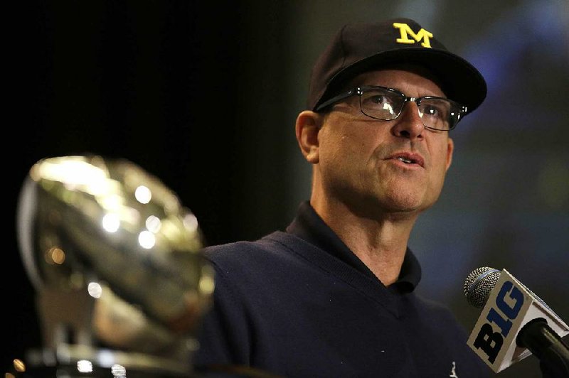Michigan football Coach Jim Harbaugh said he avoided doing any fun stuff while in Chicago for Big Ten media days, but told the media that the Wolverines must “strap on the iron jock and work like crazy” for fall practice. 