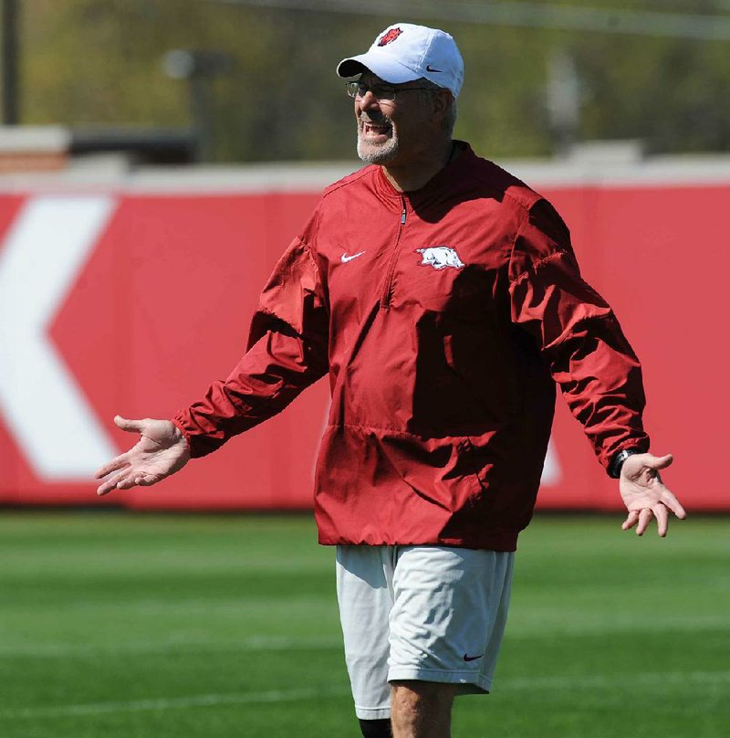 Arkansas defensive coordinator Paul Rhoads speaks to his players April 1 during a drill at the university practice field in Fayetteville.