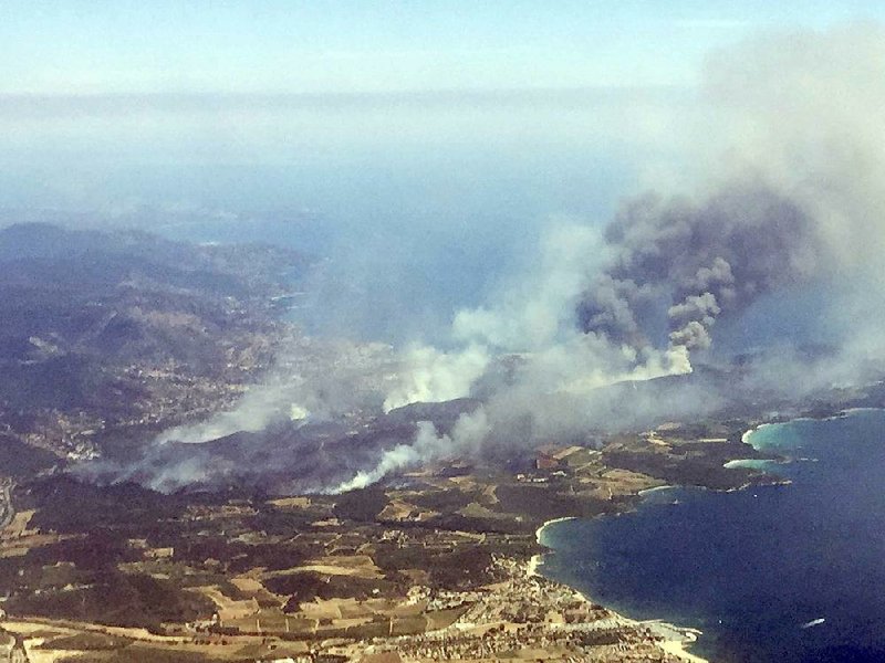 Wildfires burn Wednesday on the outskirts of the town of Bormes-les-Mimosas on the French Riviera. 