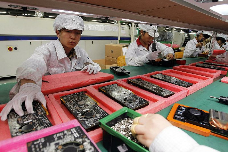 Foxconn production line employees work in a factory in the southern Chinese city of Shenzhen in 2010. Plans for Foxconn to build a $10 billion factory in Wisconsin were announced Wednesday in Washington. 