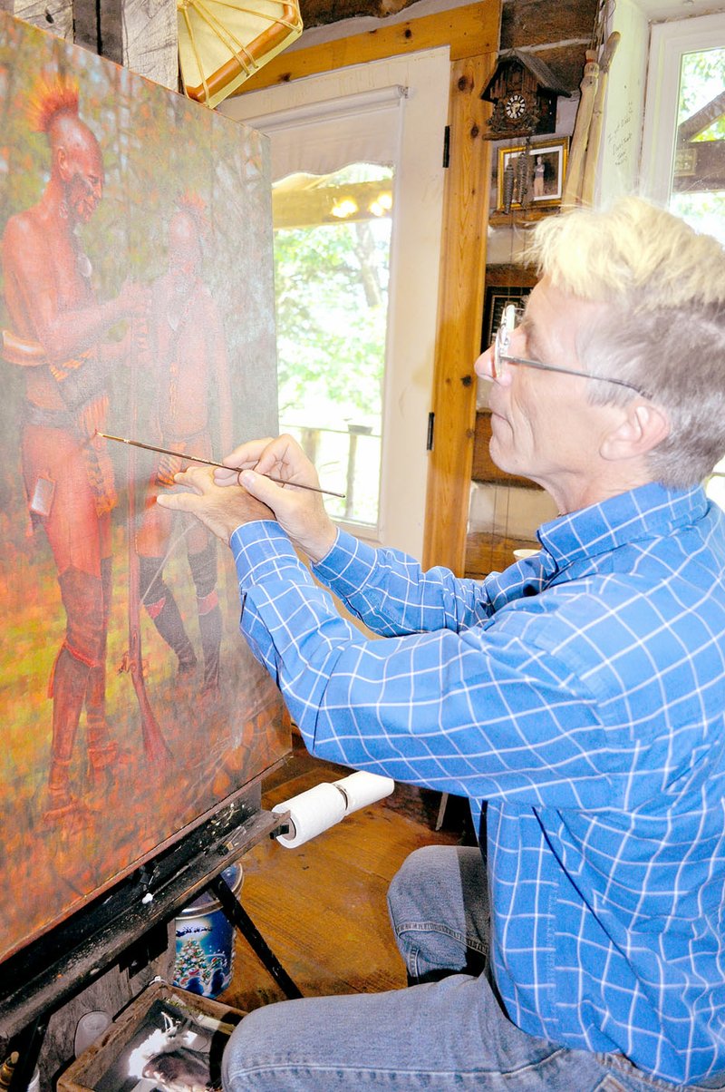 RACHEL DICKERSON/MCDONALD COUNTY PRESS Artist Doug Hall touches up a painting at his cabin in the woods near Pineville. Hall has been painting his entire life and now paints for museums.