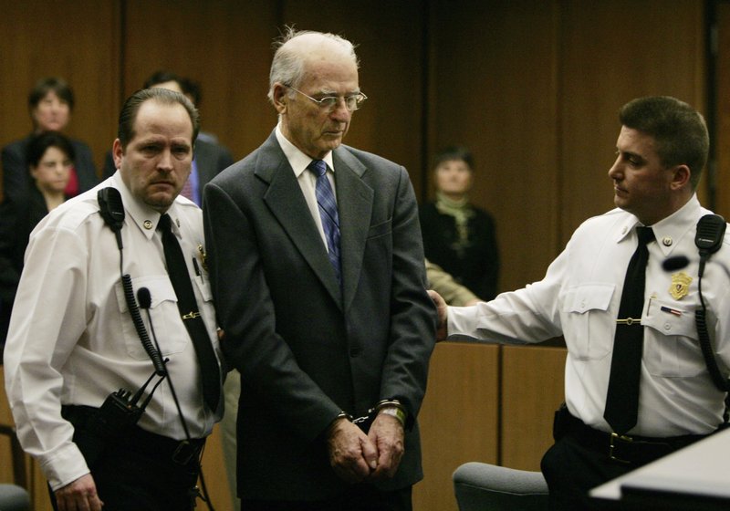 FILE--In this Feb. 15, 2005 file photo defrocked priest Paul Shanley is led from Middlesex Superior Court in Cambridge, Mass. in handcuffs following his sentence of 12 to 15 years in prison for raping a boy repeatedly in the 1980s. Prosecutors in Massachusetts say that Shanley, one of the most notorious figures in the Boston clergy sex abuse scandal, has completed his sentence on child rape charges and will be released from prison this week. (AP Photo/Charles Krupa, File)