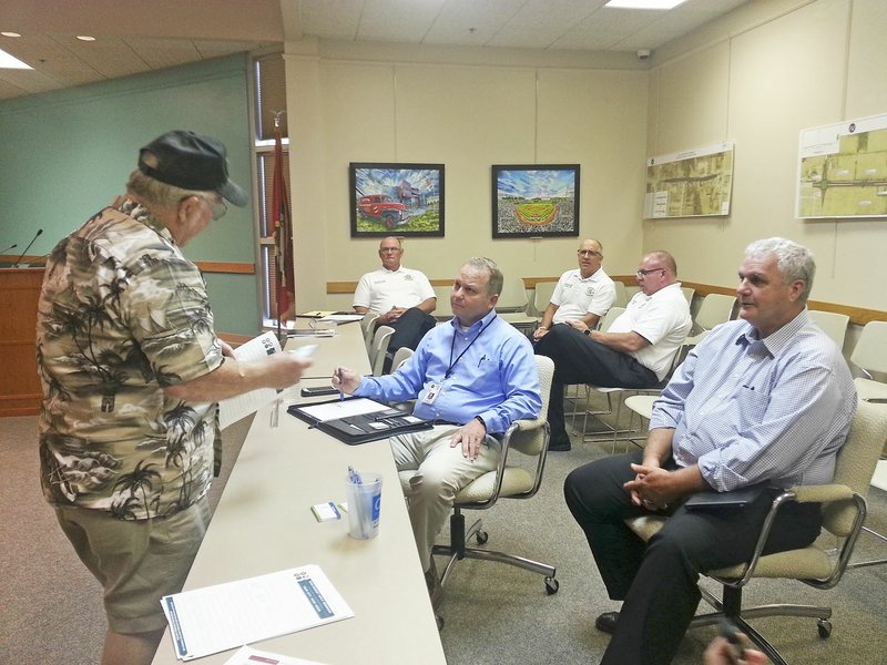 NWA Democrat-Gazette/HICHAM RAACHE Randy Bush (left) of Springdale speaks Thursday with Police Chief Mike Peters (center) and Mayor Doug Sprouse (right) about speeders in his Crestwood Street neighborhood. Bush was one of several residents providing feedback about the city's 2018 budget during a session at the City Administration Building.