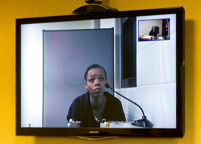 Lovily Kristine-Anwonette Johnson appears on a video monitor for her arraignment at Wyoming District Court on Monday, July 24, 2017, in Wyoming, Mich.